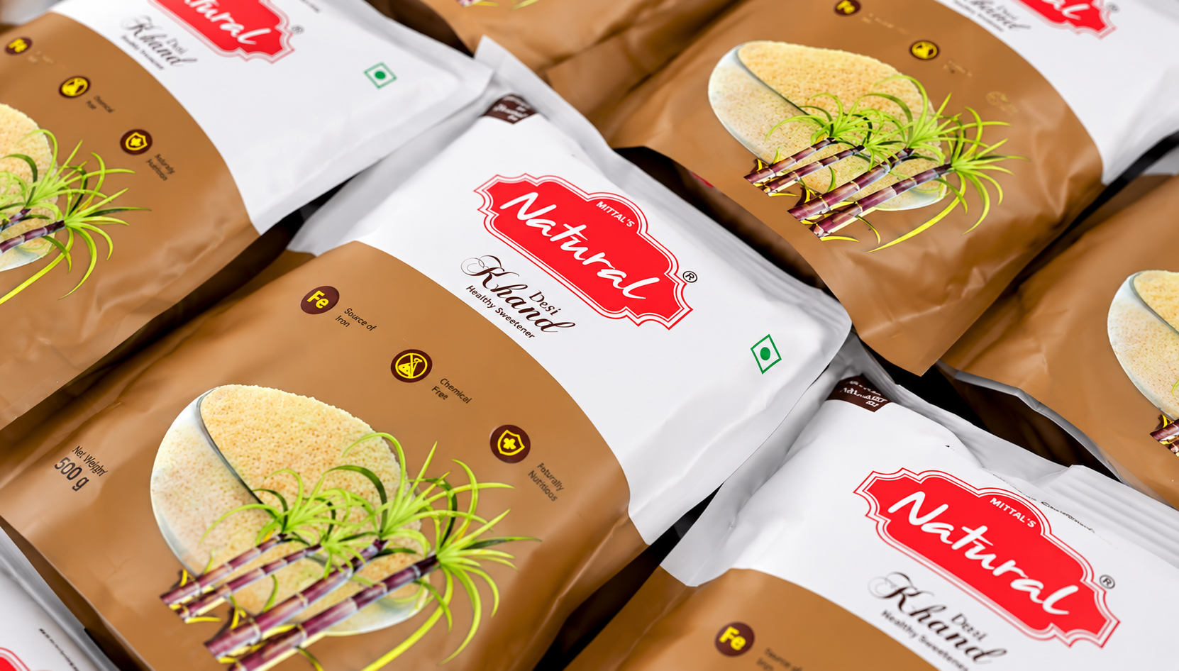 Rows of sealed Mittal's Natural Desi Khand 500 g packs lined up after packing